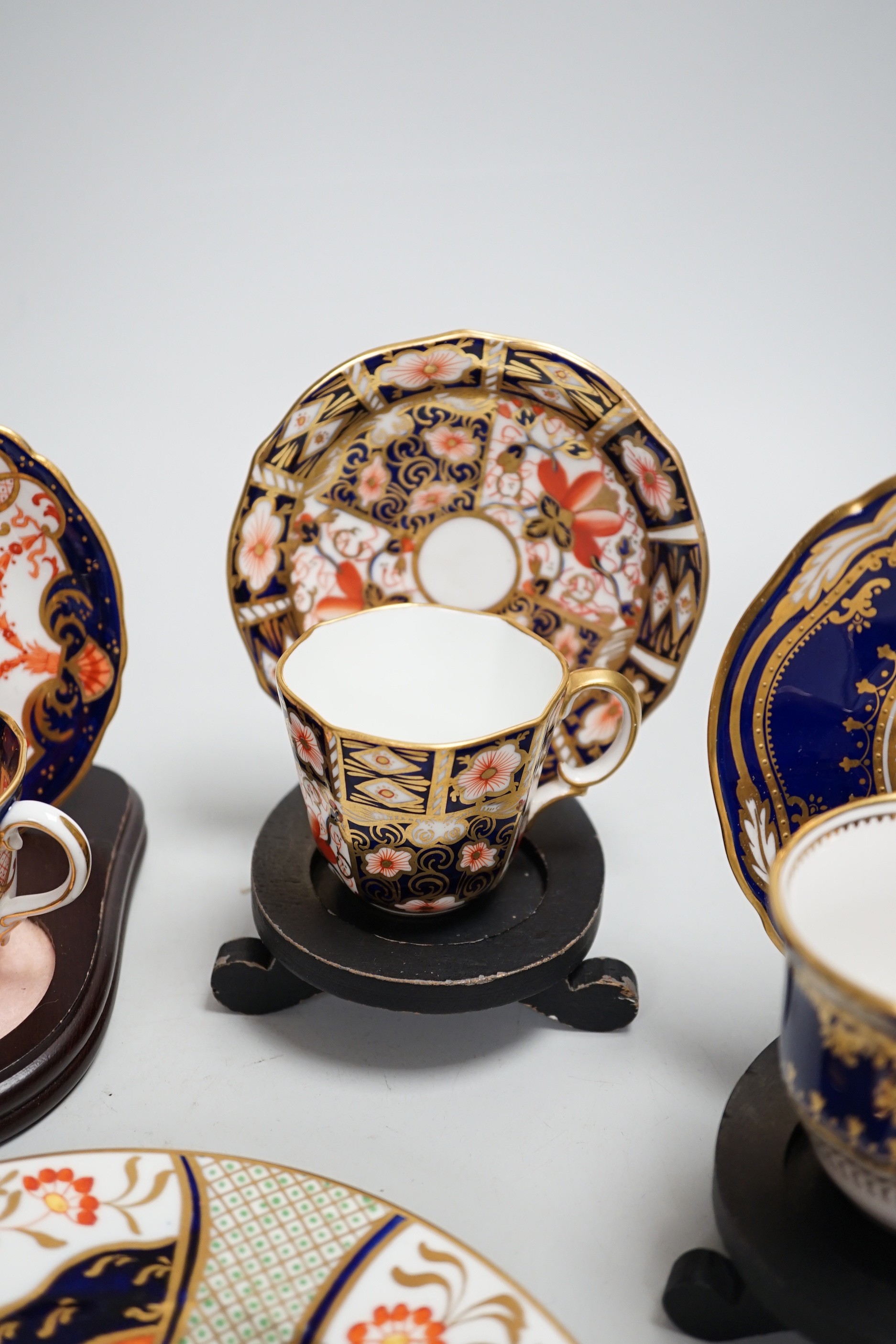 Three pairs of Royal Crown Derby porcelain cups and saucers, another Spode and a Victorian trio